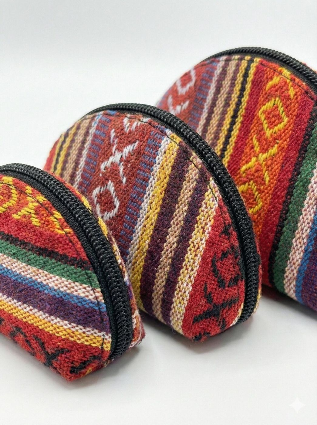 Set of three woven cotton and hemp coin purses in red patterns