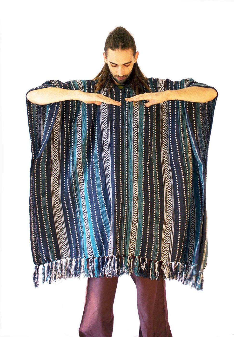 Man holding his arms out to show how wide the extra long poncho is