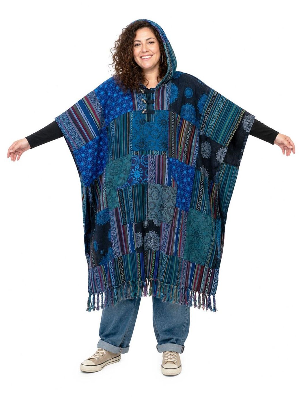 Woman with her arms out in the patchwork poncho