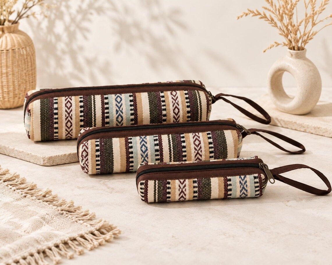 Three woven zipper pouches on a table